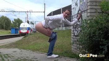 Public Peeing - Brunette babe relieves herself in front of a packed train